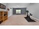 Spacious bonus room with an exercise bike, large window, carpet and natural light at 117 Constance Dr, Locust Grove, GA 30248