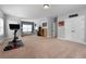 Spacious bonus room with an exercise bike, large window, carpet and natural light at 117 Constance Dr, Locust Grove, GA 30248