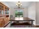 This dining room features a window, chandelier, wooden table, and a wooden hutch at 117 Constance Dr, Locust Grove, GA 30248
