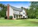 Well-manicured lawn and landscaping enhance this traditional two-story home's curb appeal at 117 Constance Dr, Locust Grove, GA 30248