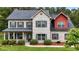 Charming two-story home featuring a brick facade, complemented by a well-maintained lawn and mature landscaping at 117 Constance Dr, Locust Grove, GA 30248
