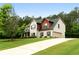 Beautiful two-story home with brick and vinyl exterior, attached garage, and lush landscaping at 117 Constance Dr, Locust Grove, GA 30248