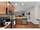 The kitchen features wooden cabinets, stainless steel appliances, and granite countertops at 117 Constance Dr, Locust Grove, GA 30248
