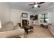 The living room has carpeted floors, neutral walls, a fireplace, and a ceiling fan at 117 Constance Dr, Locust Grove, GA 30248