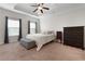 Spacious main bedroom featuring a tray ceiling, plush carpet, and ample natural light at 117 Constance Dr, Locust Grove, GA 30248