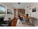Staged home office featuring hardwood floors, ample natural light, and built-in shelving and desk at 117 Constance Dr, Locust Grove, GA 30248