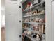 Well-organized pantry with multiple shelves provides ample storage for food and kitchen essentials at 117 Constance Dr, Locust Grove, GA 30248