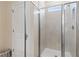 Modern bathroom featuring a tiled walk-in shower with glass door and chrome fixtures at 15 Camellia Dr, Fairburn, GA 30213