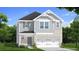Charming two-story home featuring a brick and gray siding exterior with a two-car garage and well-manicured lawn at 15 Camellia Dr, Fairburn, GA 30213