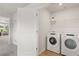 Convenient laundry room with modern appliances and shelving for storage at 15 Camellia Dr, Fairburn, GA 30213