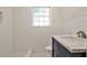 Modern bathroom with navy vanity, stylish marble countertop, subway tile walls, and sleek fixtures at 1986 N Decatur Ne Rd, Atlanta, GA 30307