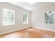 Bright bedroom featuring hardwood floors, three windows, and neutral paint, creating a serene and airy atmosphere at 1986 N Decatur Ne Rd, Atlanta, GA 30307