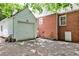 View of home's brick exterior and detached garage with white siding and concrete driveway at 1986 N Decatur Ne Rd, Atlanta, GA 30307