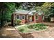 Charming brick home featuring black shutters, a landscaped yard, and a paved walkway at 1986 N Decatur Ne Rd, Atlanta, GA 30307
