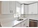 Bright kitchen featuring white cabinets, stainless steel appliances, and solid countertops with a modern and clean aesthetic at 1986 N Decatur Ne Rd, Atlanta, GA 30307
