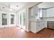 Cozy sunroom with white cabinets, stainless steel appliances, many windows allowing for natural light and a fan at 1986 N Decatur Ne Rd, Atlanta, GA 30307