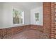 Enclosed porch or sunroom with brick floors and wainscoting, providing a rustic yet bright space at 1986 N Decatur Ne Rd, Atlanta, GA 30307