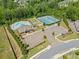 Aerial view of community amenities: pool, playground, tennis courts, and parking at 410 Gardens Of Harmony Dr, Canton, GA 30115