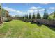 Lush green back yard with well-maintained lawn and trees offering shade at 410 Gardens Of Harmony Dr, Canton, GA 30115