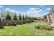 Spacious back yard with a wooden fence providing privacy and landscaping at 410 Gardens Of Harmony Dr, Canton, GA 30115