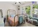 Well-lit bedroom featuring large windows, stylish furniture and a cozy bed at 410 Gardens Of Harmony Dr, Canton, GA 30115