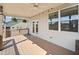 Covered back deck with ceiling fan, string lights, and seating area overlooking the yard at 410 Gardens Of Harmony Dr, Canton, GA 30115