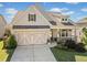 Charming two-story home boasts a manicured lawn and a welcoming front porch at 410 Gardens Of Harmony Dr, Canton, GA 30115