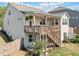 Two-story home with fenced yard, deck, patio, and stair access from backyard at 410 Gardens Of Harmony Dr, Canton, GA 30115