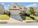 Charming two-story home boasts a manicured lawn and a welcoming front porch at 410 Gardens Of Harmony Dr, Canton, GA 30115