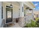 Inviting covered front porch with classic columns and stylish welcome decor at 410 Gardens Of Harmony Dr, Canton, GA 30115