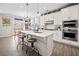 Open concept kitchen with stainless appliances, white cabinets, and a breakfast bar island at 410 Gardens Of Harmony Dr, Canton, GA 30115