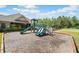 Community playground featuring slides and a play structure near a clubhouse at 410 Gardens Of Harmony Dr, Canton, GA 30115
