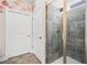 Shower features tiled walls, a shower head, and a glass door at 410 Gardens Of Harmony Dr, Canton, GA 30115