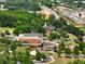 Aerial view of a brick building surrounded by trees, parking and walkways, enhancing its appeal and accessibility at 4905 Sterling Close, Buford, GA 30518