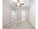 Bedroom featuring a ceiling fan, neutral carpet, and multiple doorways at 4905 Sterling Close, Buford, GA 30518