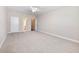 Spacious bedroom with neutral carpet, ceiling fan, and access to the bathroom and doorway at 4905 Sterling Close, Buford, GA 30518