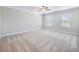 Spacious bedroom with plush carpeting, neutral walls, and natural light from multiple windows at 4905 Sterling Close, Buford, GA 30518