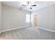 Spacious bedroom featuring a ceiling fan and a walk-in closet at 4905 Sterling Close, Buford, GA 30518