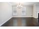 Hardwood floored dining room with chandelier and windows allows ample natural light at 4905 Sterling Close, Buford, GA 30518