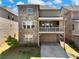 Brick two-story home with a covered patio above the garage and a well-manicured lawn at 4905 Sterling Close, Buford, GA 30518