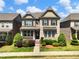 Charming two-story home with stone accents, manicured lawn, and mature landscaping at 4905 Sterling Close, Buford, GA 30518