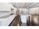 Modern kitchen with granite countertops, island, and white cabinets has great appeal at 4905 Sterling Close, Buford, GA 30518