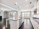 Open kitchen featuring granite countertops, a center island, and stainless steel appliances at 4905 Sterling Close, Buford, GA 30518