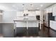Open kitchen with stainless appliances, island, and white cabinets is perfect for entertaining at 4905 Sterling Close, Buford, GA 30518
