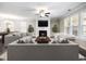 Bright living room features a fireplace, ceiling fan, neutral colors, and large windows with wood blinds at 4905 Sterling Close, Buford, GA 30518