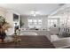 Open concept living room with fireplace, modern furniture, and lots of natural light at 4905 Sterling Close, Buford, GA 30518