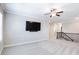 Bright loft area with neutral walls, plush carpet, ceiling fan, and modern staircase at 4905 Sterling Close, Buford, GA 30518