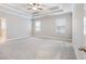Spacious main bedroom featuring plush carpet, tray ceiling, and ample natural light at 4905 Sterling Close, Buford, GA 30518