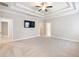 Spacious main bedroom with plush carpet and tray ceiling at 4905 Sterling Close, Buford, GA 30518