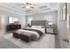 Bright main bedroom with bed, ceiling fan, tray ceiling, carpet, and white trim at 4905 Sterling Close, Buford, GA 30518